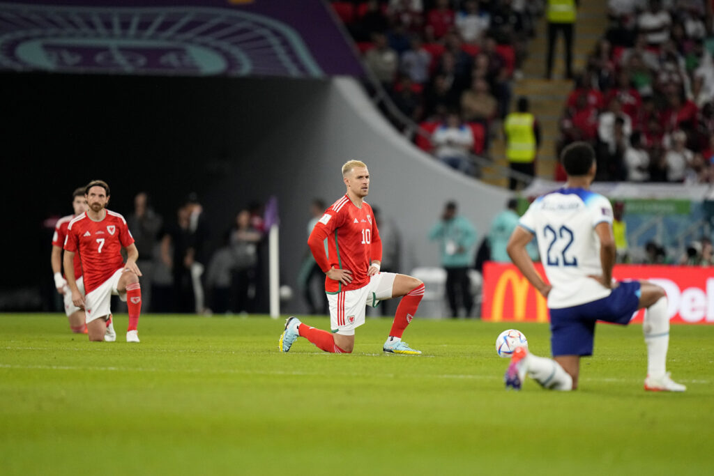 Wales and England players on their knees
